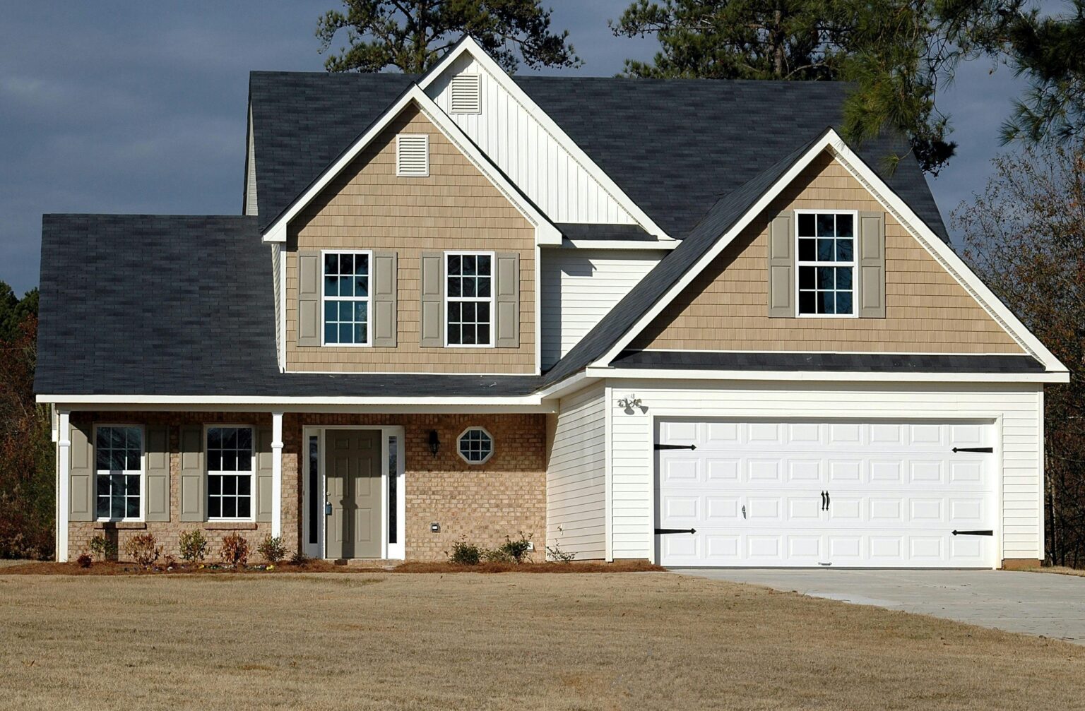 A house with two garage doors and a driveway.