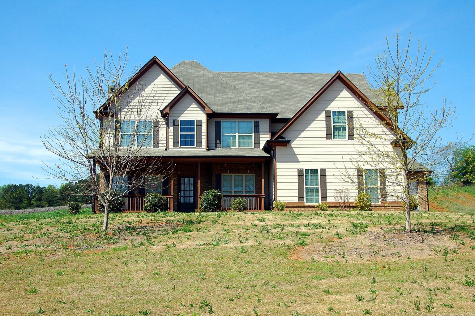 A large white house sitting on top of a hill.